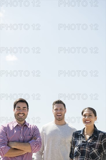 Smiling friends posing outdoors