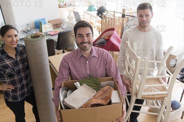 Smiling friends moving house