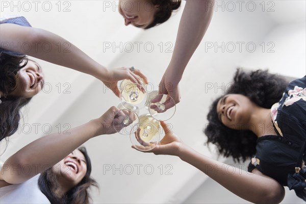 Smiling women toasting with white wine