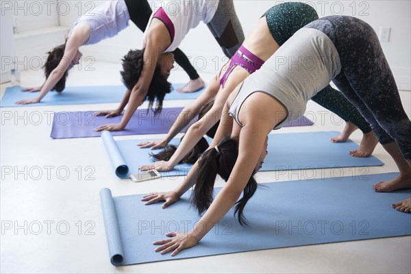 Women bending in yoga class