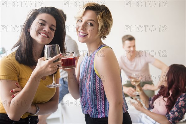 Portrait of smiling women toasting at party