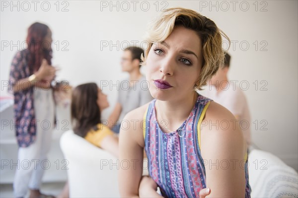 Portrait of woman sulking at party