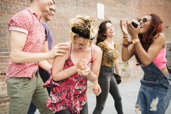 Friends laughing in city