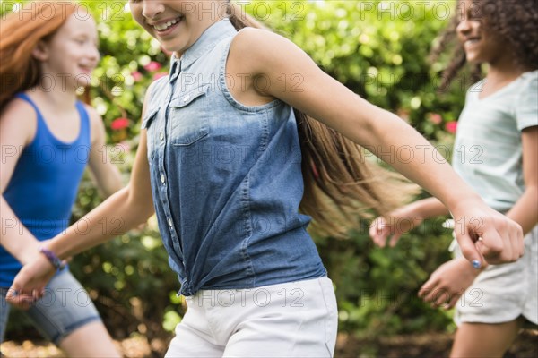 Smiling girls running outdoors