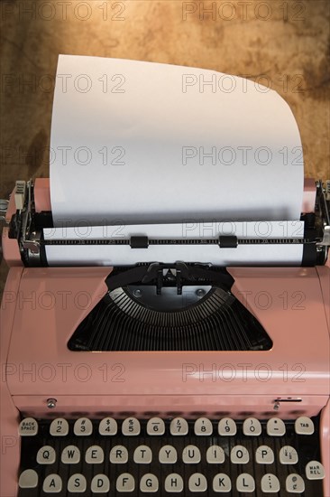 Blank paper in pink typewriter