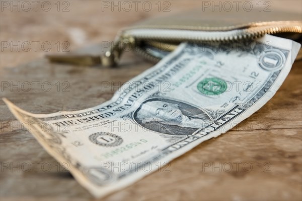 Close up of dollar on wooden table near wallet