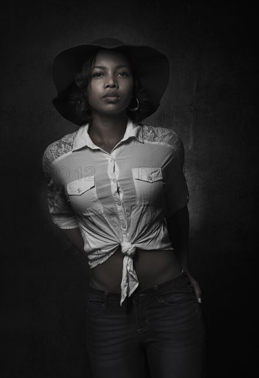 Portrait of serious mixed race woman wearing hat