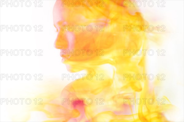 Double exposure of face of Mixed Race woman and fire