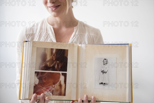 Caucasian woman showing photo album