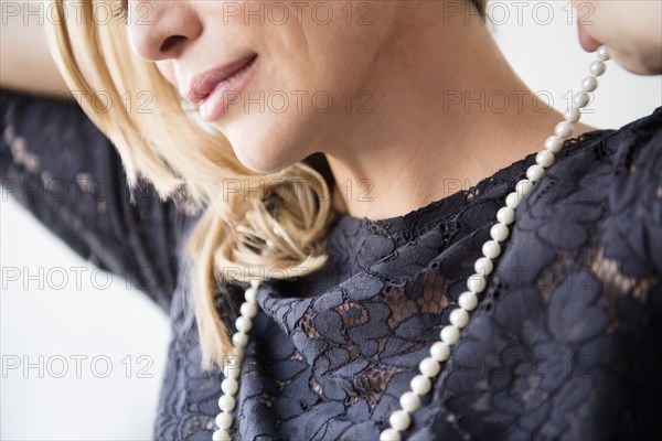 Caucasian woman wearing pearl necklace