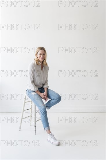 Caucasian woman sitting on stool