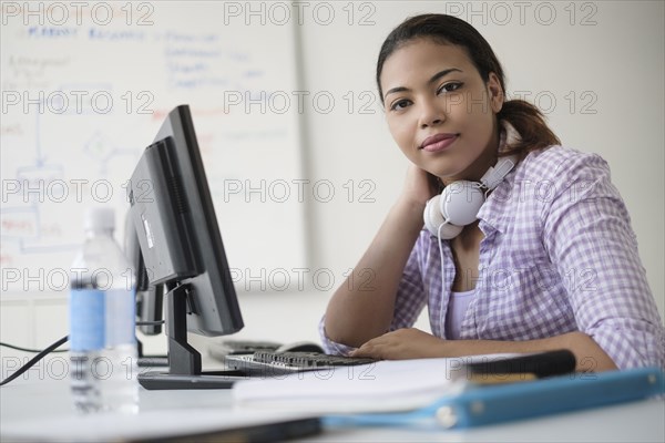 Portrait of smiling Hispanic woman in computer lab