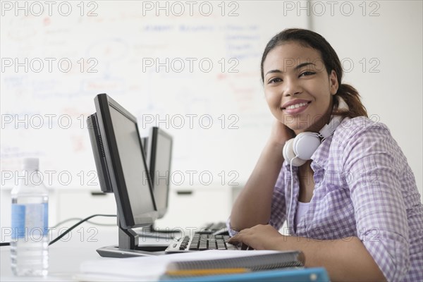 Portrait of smiling Hispanic woman in computer lab