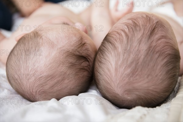 Top of heads of Caucasian twin baby girls