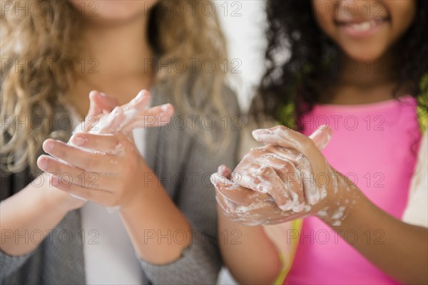 Girls washing hands with soap