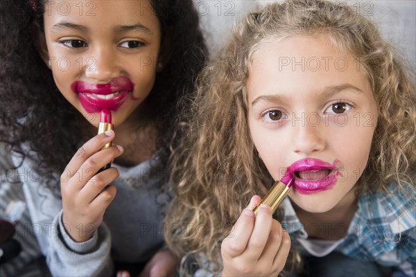 Girls applying messy lipstick