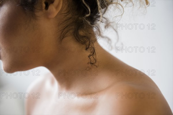 Neck and bare shoulders of Mixed Race woman