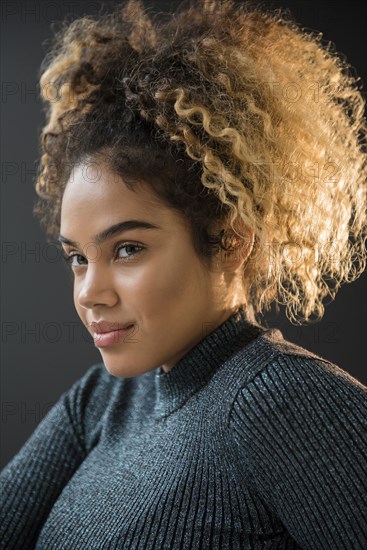 Portrait of Mixed Race woman wearing sweater