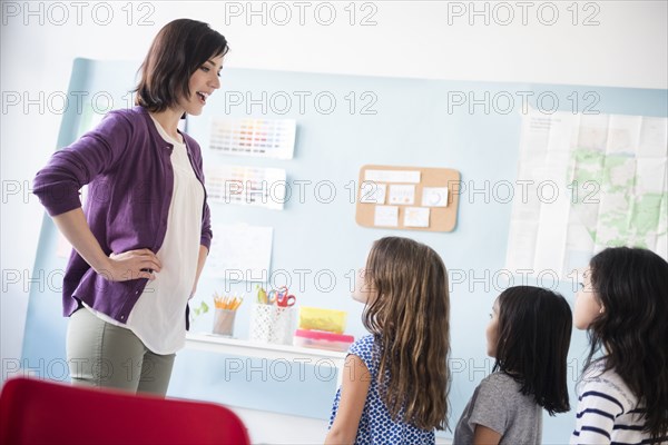 Girls standing in a row for teacher in classroom