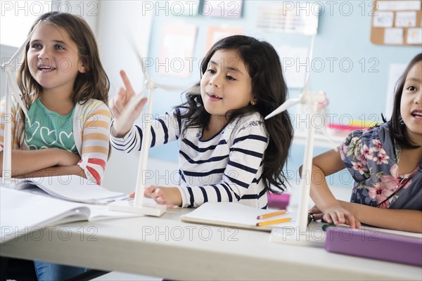 Girls learning about windmills in classroom