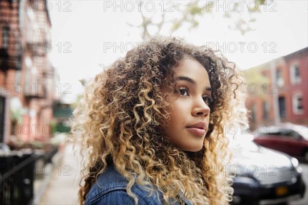 Pensive Mixed Race woman in city