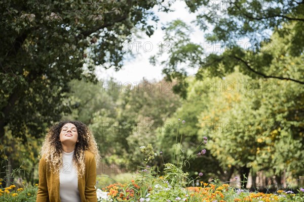 Mixed Race woman relaxing in park