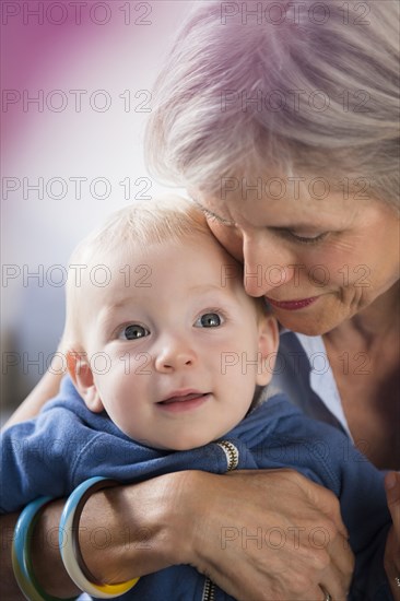 Portrait of smiling Caucasian grandmother hugging baby grandson