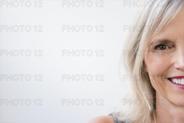 Portrait of half of face of smiling Caucasian woman