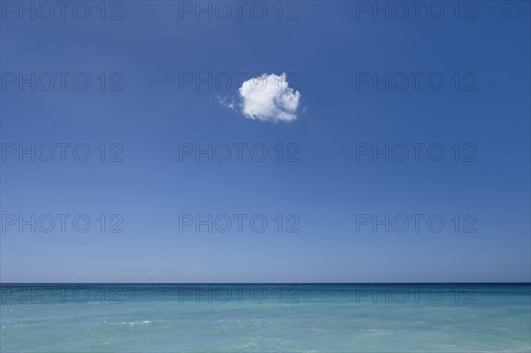 Cloud in blue sky over ocean