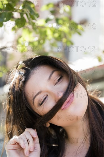 Caucasian woman holding hair on lip imitating mustache