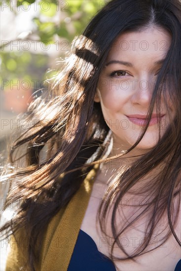 Wind blowing hair of Caucasian woman