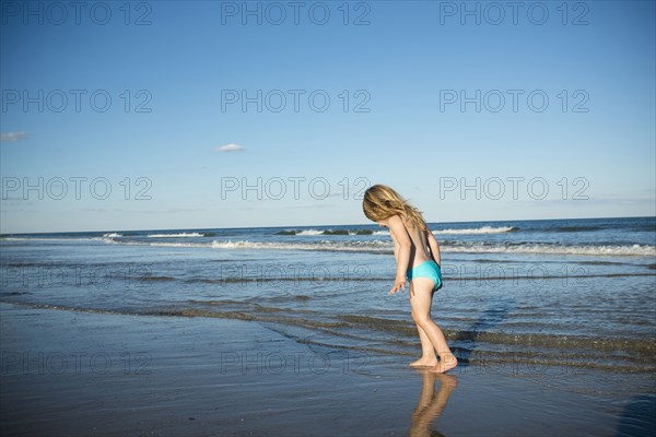 Caucasian girl walking on beach