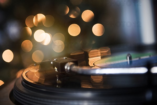 Close up of tonearm on spinning record player