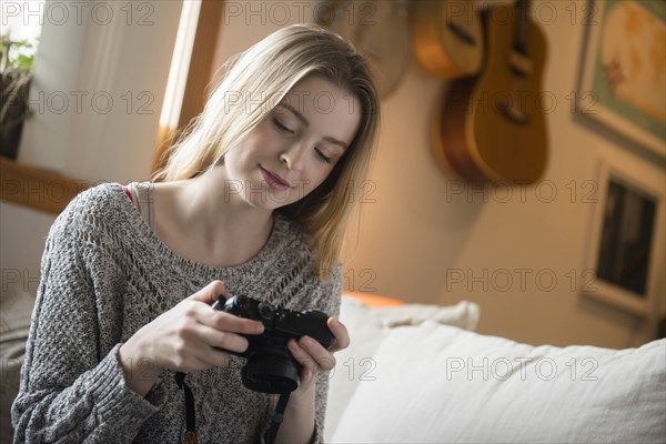 Woman examining camera