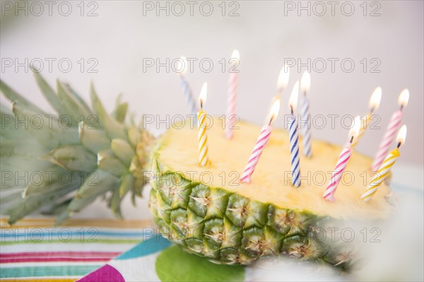 Candles burning in half of sliced pineapple