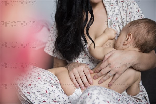 Caucasian mother breastfeeding baby son