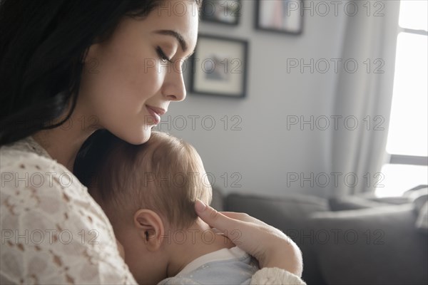 Caucasian mother comforting baby son