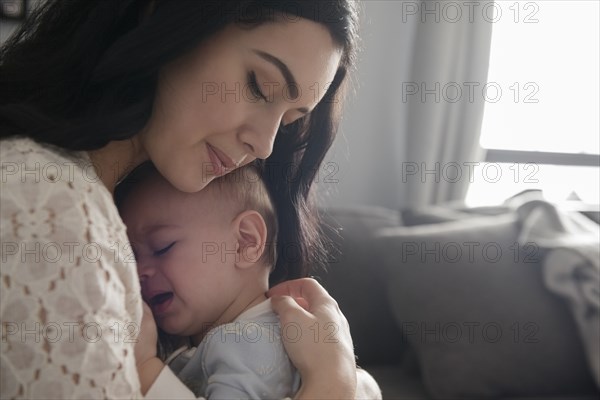 Caucasian mother comforting crying baby son