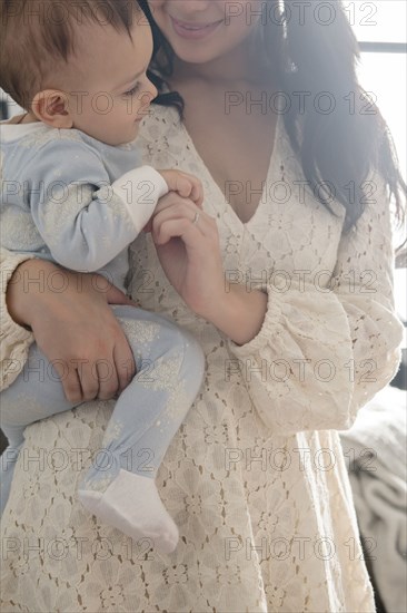 Caucasian mother holding baby son