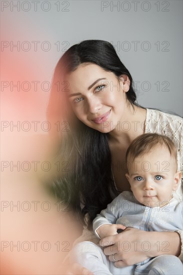 Portrait of Caucasian mother holding son in lap