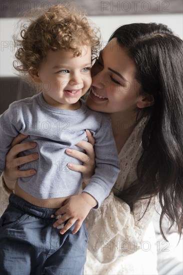 Caucasian mother hugging son