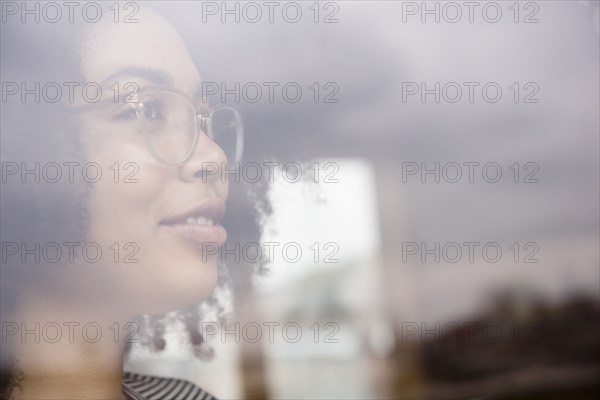 Smiling African American woman behind window