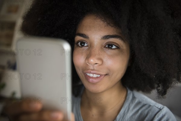 African American woman texting on cell phone