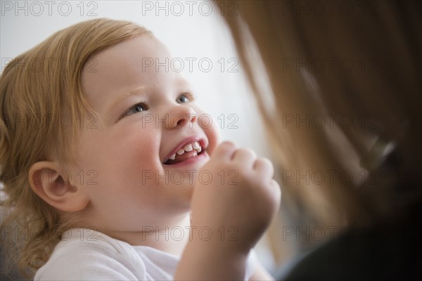 Caucasian girl smiling at mother