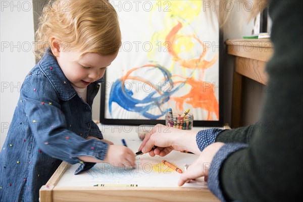 Caucasian mother and daughter coloring