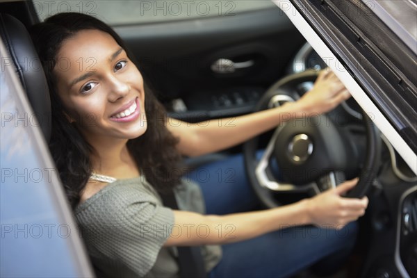 View from sunroof of Hispanic woman driving car