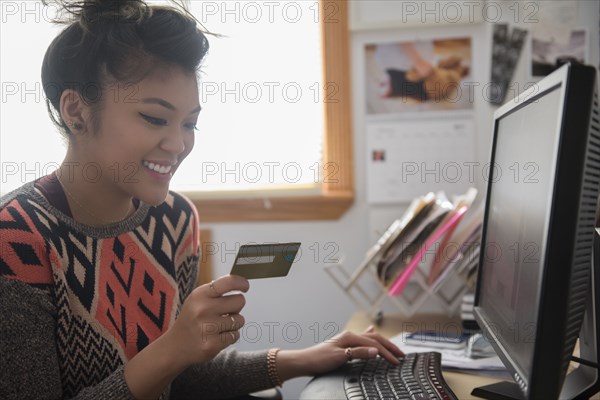 Mixed Race woman online shopping using computer