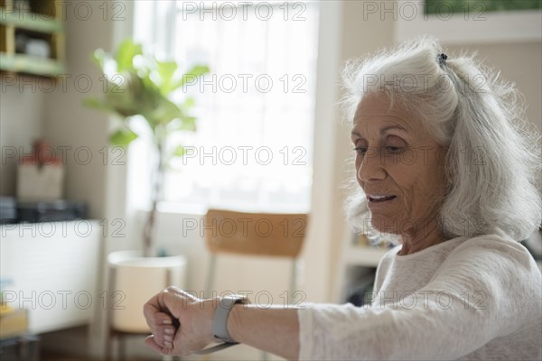 Older woman checking wristwatch