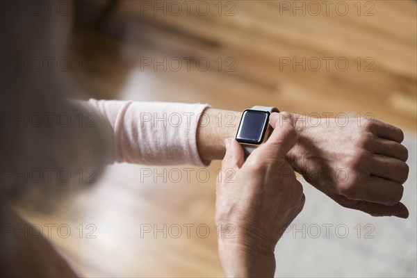 Older woman checking smart watch