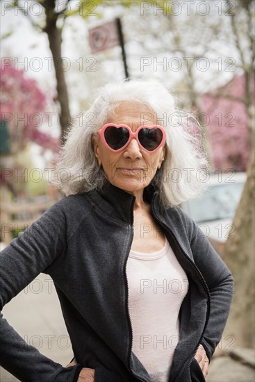 Older woman wearing heart-shape sunglasses